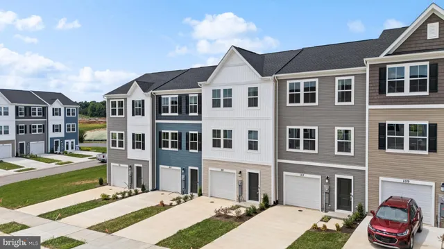 a front view of a residential apartment building with a yard