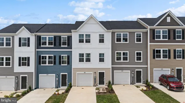 a view of a brick house with many windows and yard