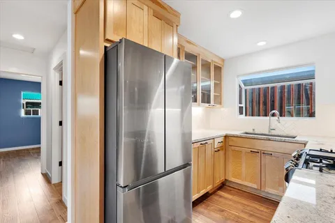 a kitchen with stainless steel appliances a refrigerator and a sink