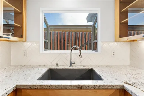 a kitchen with granite countertop a sink and a granite top