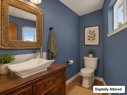 a bathroom with a toilet a sink and mirror