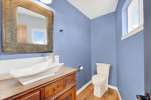 a bathroom with a toilet sink and mirror