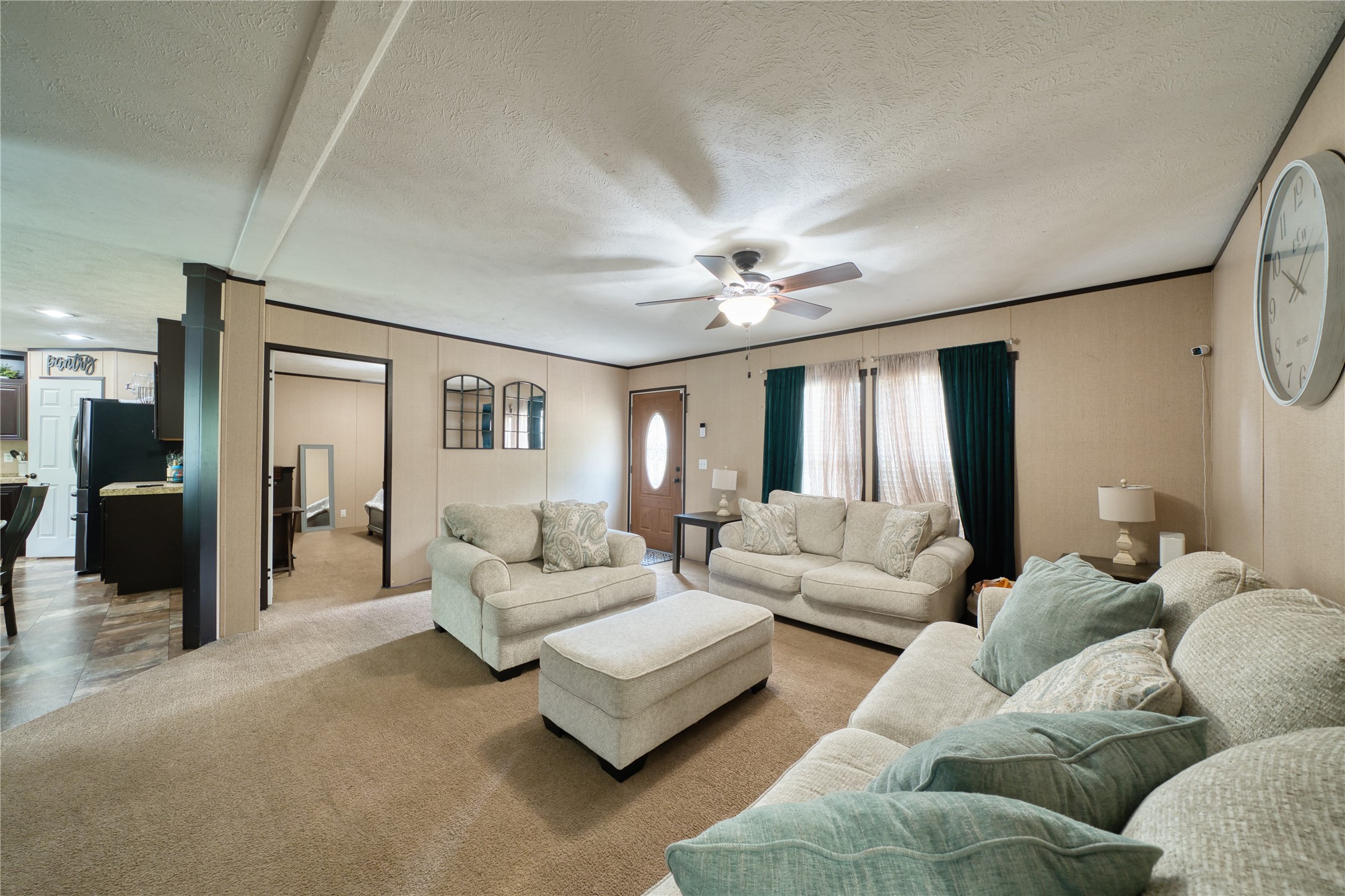 103 County Road 370 Splendora, TX 77372 - Photo 2 of 32 a living room with furniture and a chandelier