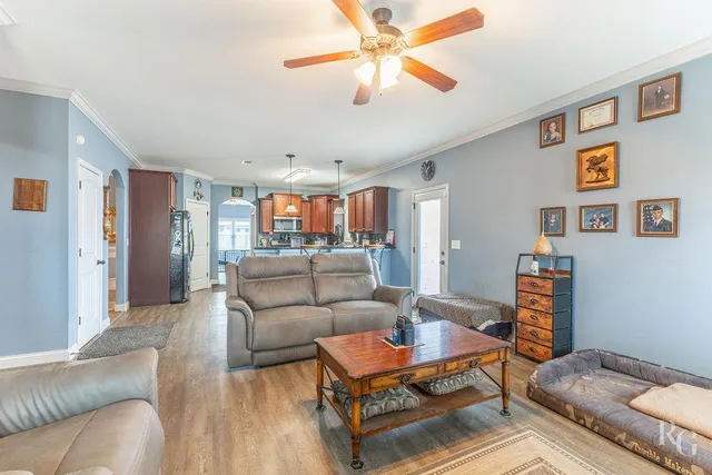 a living room with furniture and a wooden floor