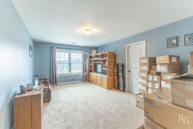 a living room with furniture a flat screen tv and next to a window