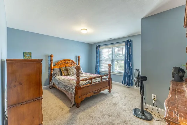 a bedroom with a bed and a dresser