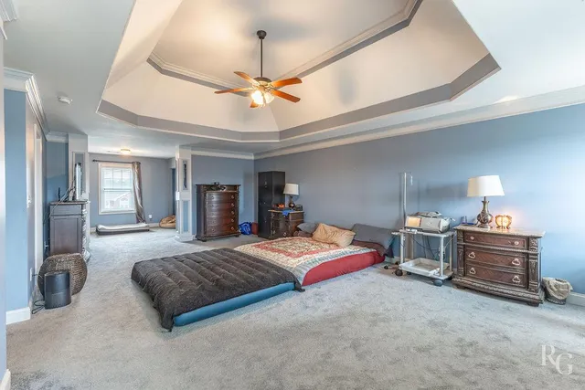 a bedroom with a bed and ceiling fan