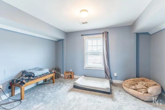 a bedroom with furniture and a window