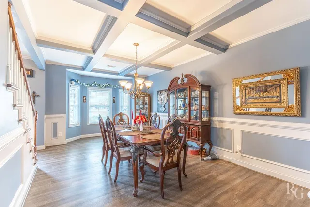 a dining room with furniture a chandelier and wooden floor