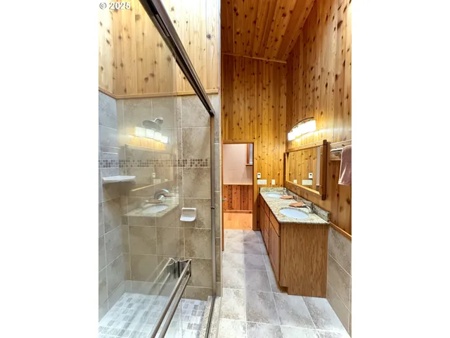 a bathroom with a shower and a sink