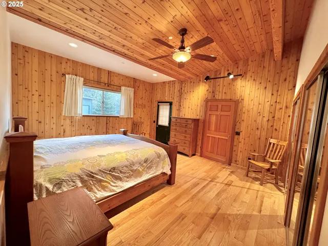 a spacious bedroom with a bed and a mirror