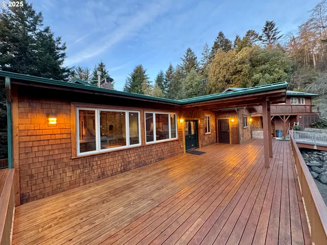 a view of a house with pool and wooden floor