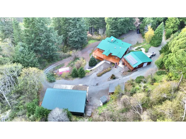 an aerial view of a house with a yard and trees