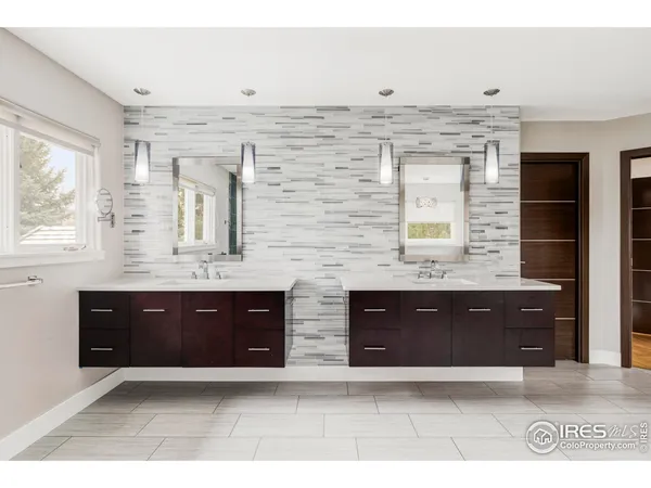 a spacious bathroom with double vanity and a bathtub