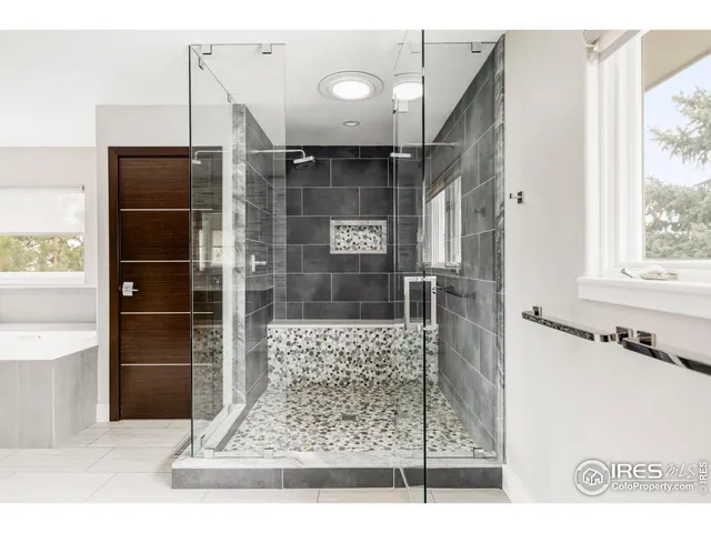 a bathroom with a glass shower door and a bathtub