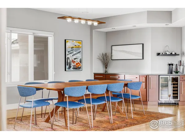 a dining room with furniture and wooden floor