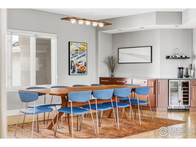 a dining room with furniture and wooden floor