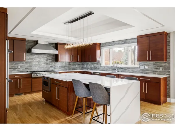 a kitchen with stainless steel appliances granite countertop a sink and a stove