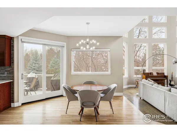 a view of a dining room with furniture a chandelier and wooden floor