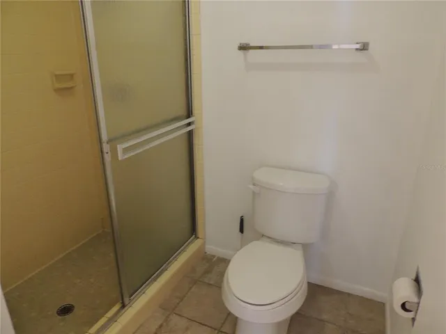 a large white bed sitting in a room next to a window