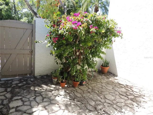 a view of a patio with table and chairs