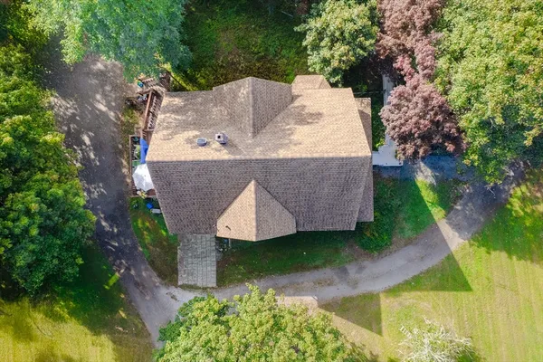 a view of backyard with table and chairs