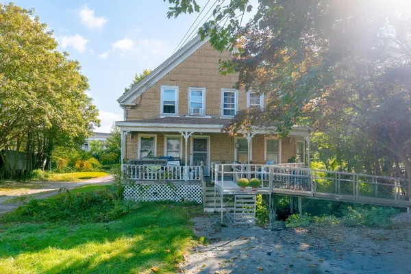 a front view of house with yard and outdoor seating