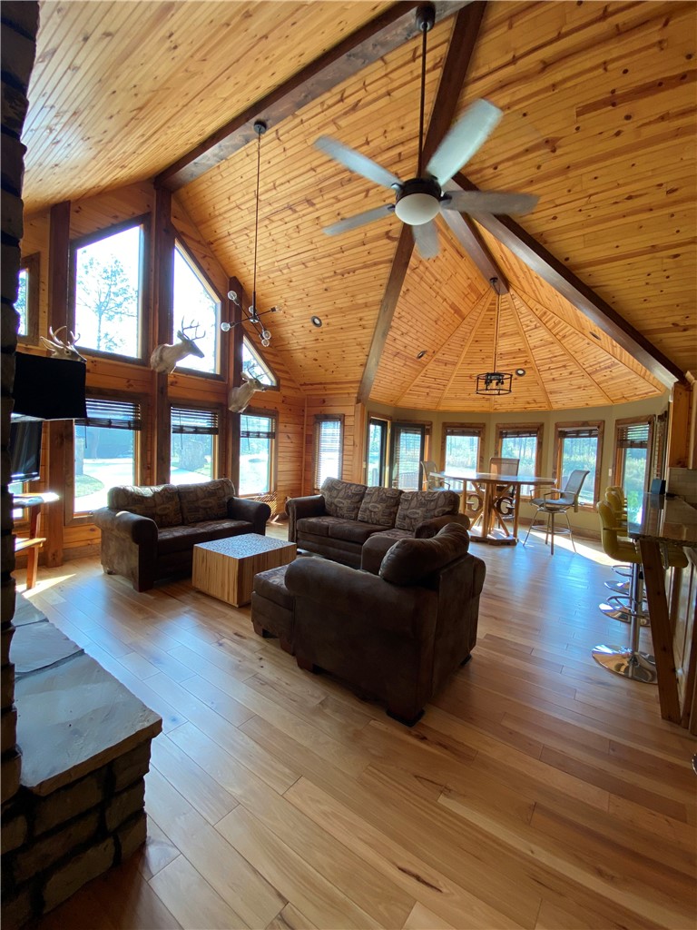 128 McAlister Road West Union, SC 29696 - Photo 12 of 40 Natural wood ceilings and floors create a warm, inviting atmosphere in this open-concept living space.