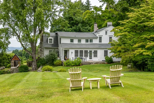 a front view of a house with a yard table and chairs