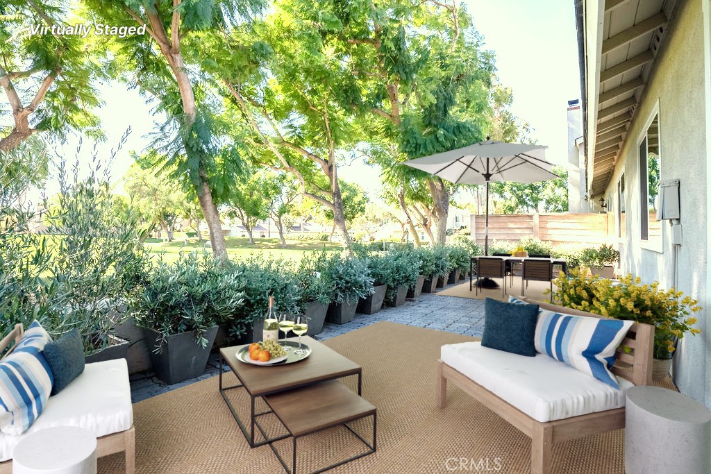 13 Brookmont, Unit 60 Irvine, CA 92604 - Photo 1 of 24 a outdoor living space with furniture and umbrella