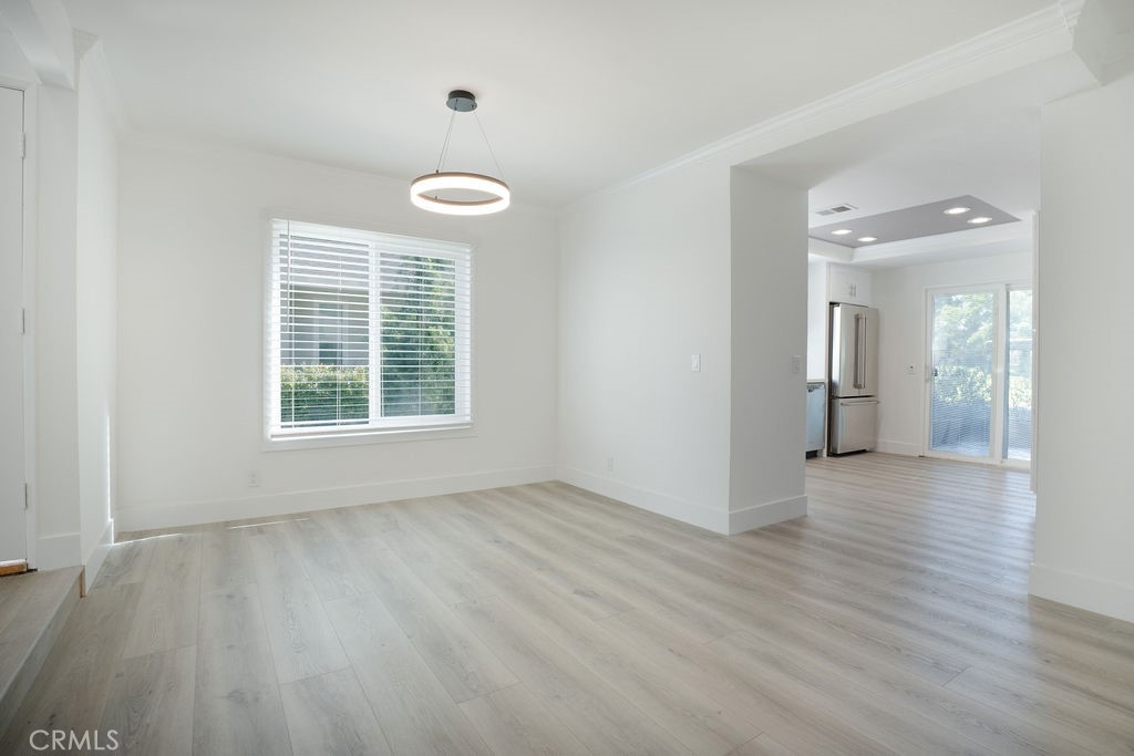 13 Brookmont, Unit 60 Irvine, CA 92604 - Photo 11 of 24 an empty room with wooden floor and windows