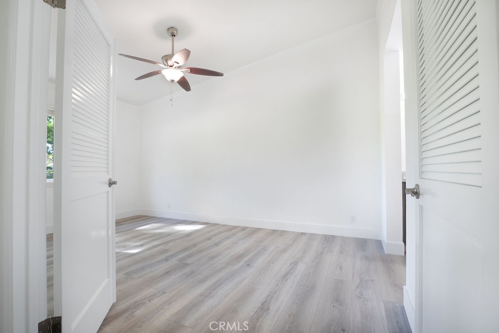 13 Brookmont, Unit 60 Irvine, CA 92604 - Photo 16 of 24 a view of a room with wooden floor closet and windows