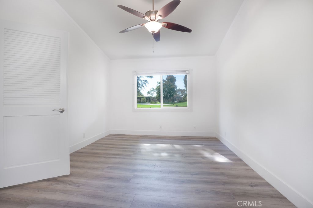 13 Brookmont, Unit 60 Irvine, CA 92604 - Photo 17 of 24 an empty room with wooden floor ceiling fan and windows