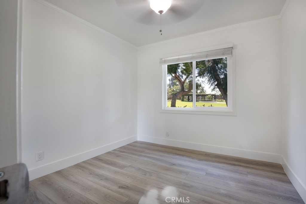 13 Brookmont, Unit 60 Irvine, CA 92604 - Photo 18 of 24 a view of an empty room with wooden floor and a window
