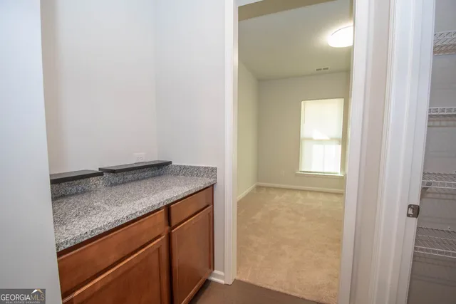 a view of walk in closet with empty racks