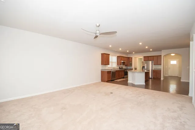 a view of kitchen with refrigerator and window