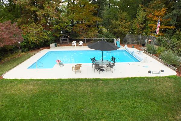 1 Blacksmith Road Chelmsford, MA 01824 - Photo 2 of 29 a view of a swimming pool with an outdoor space and seating area