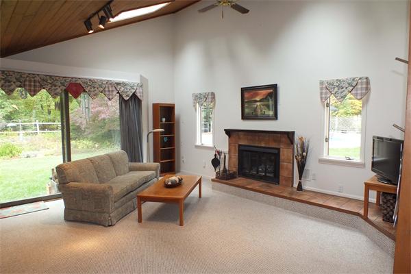 1 Blacksmith Road Chelmsford, MA 01824 - Photo 4 of 29 a living room with furniture a large window and a fireplace