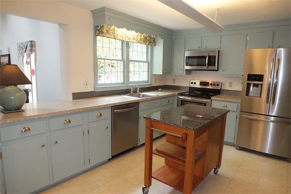 1 Blacksmith Road Chelmsford, MA 01824 - Photo 10 of 29 a kitchen with a sink a window a refrigerator and stainless steel appliances