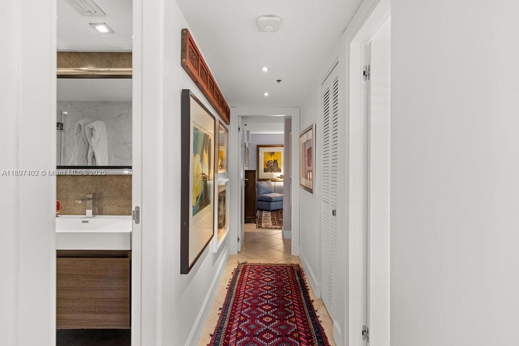 2843 South Bayshore Drive, Unit 4B Miami, FL 33133 - Photo 12 of 25 a view of a hallway with wooden floor and a bathroom