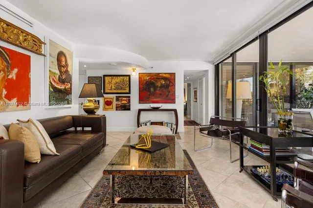 a living room with furniture and large windows