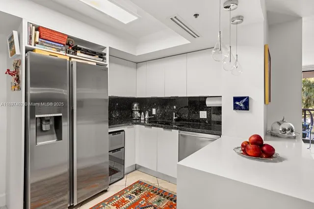 a kitchen with stainless steel appliances a refrigerator and a sink