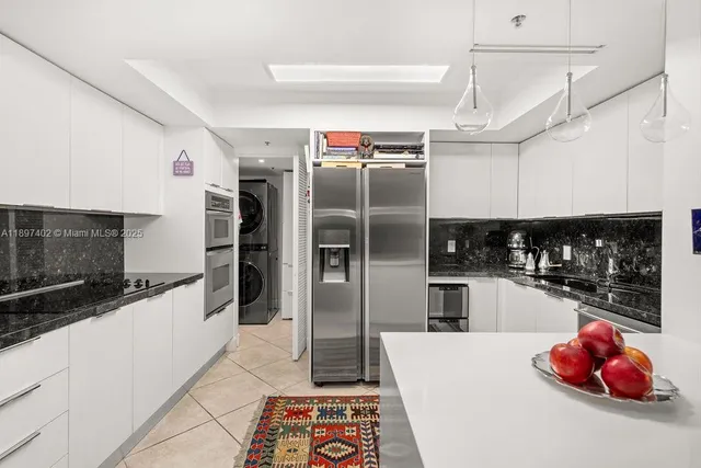 a kitchen with stainless steel appliances a refrigerator sink and microwave