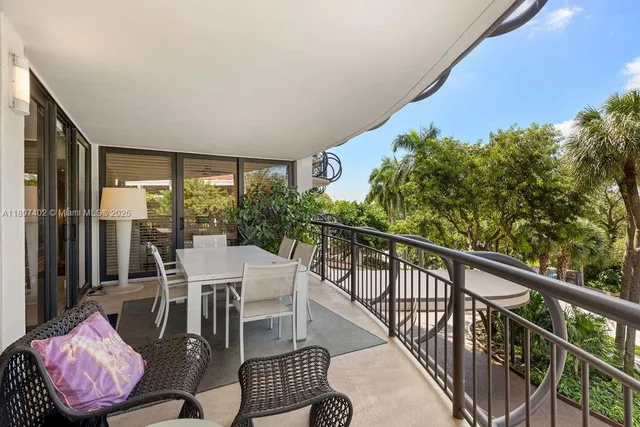 a view of a patio with couches table and chairs and potted plants