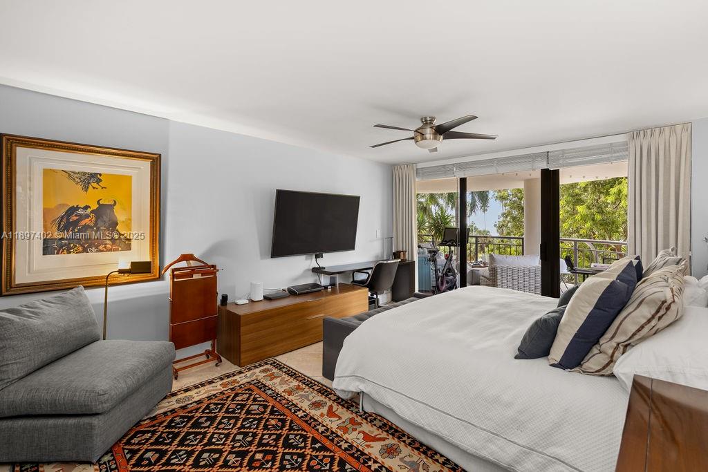 2843 South Bayshore Drive, Unit 4B Miami, FL 33133 - Photo 8 of 25 a living room with furniture a floor to ceiling window and a flat screen tv