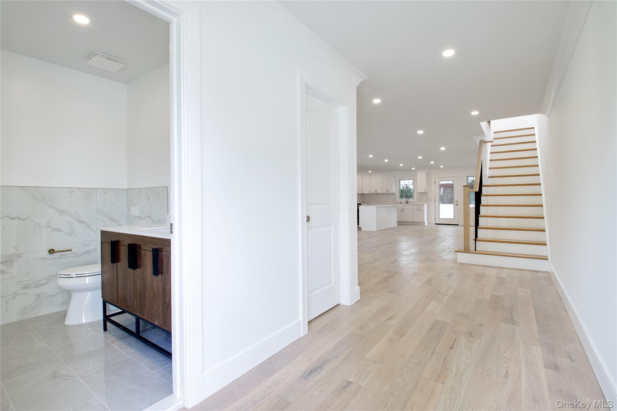30 Kirkwood Road, Unit B Port Washington, NY 11050 - Photo 10 of 36 a view of a hallway with wooden floor and staircase