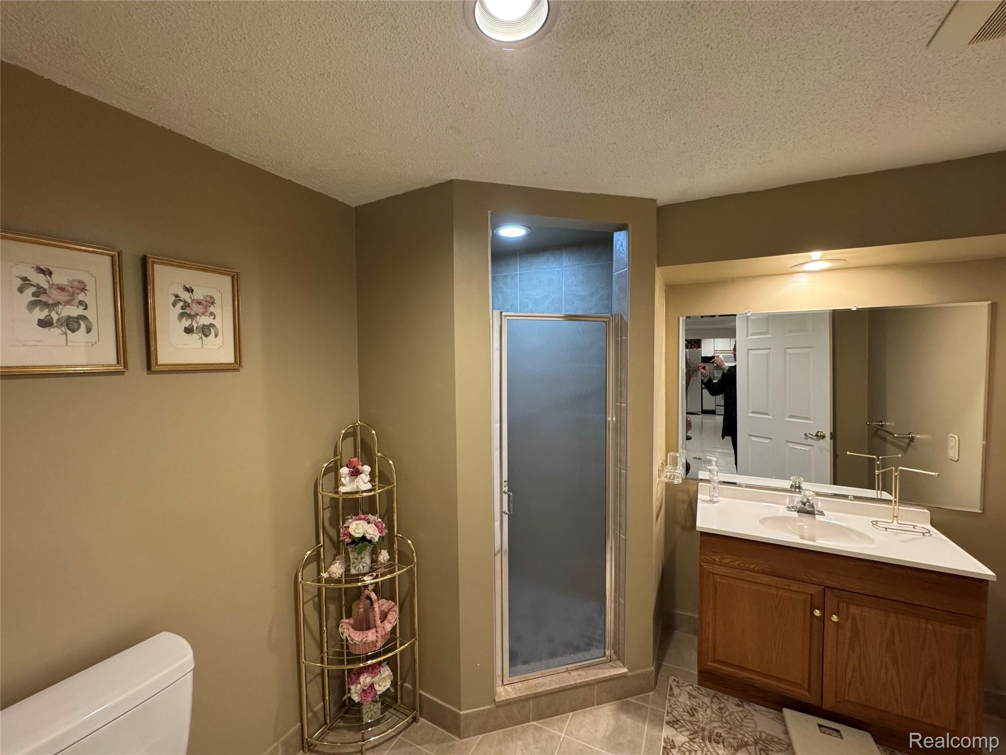 48583 Tilch Road Macomb, MI 48044 - Photo 41 of 53 Full bathroom featuring vanity, a stall shower, a textured ceiling, light tile patterned floors, and recessed lighting