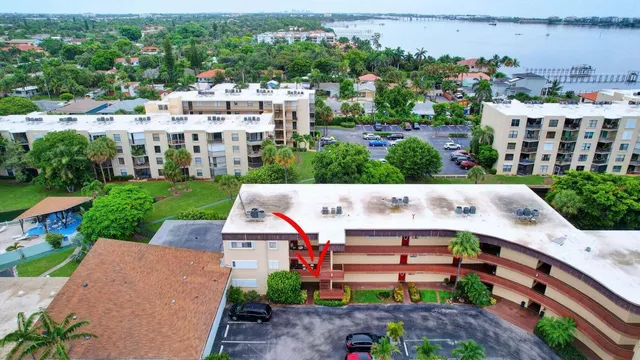 an aerial view of a house with a garden and trees