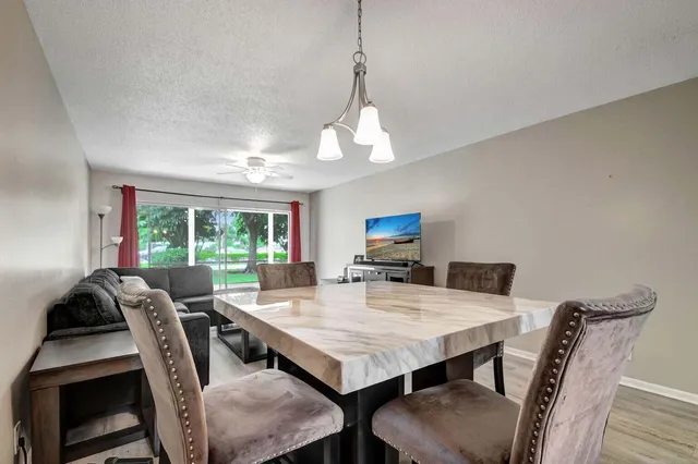 a view of a dining room with furniture window and outside view
