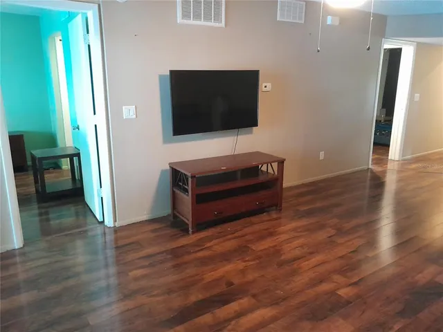 a view of a porch with a floor to ceiling window and tree